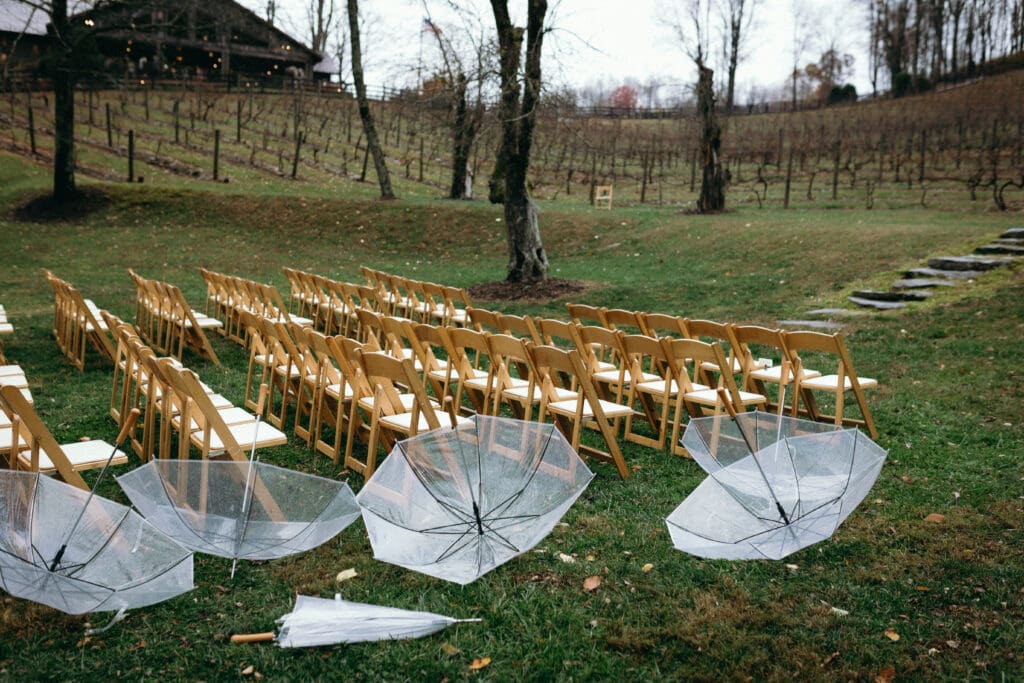 Deserted chairs and umbrellas after a a rainy wedding ceremony