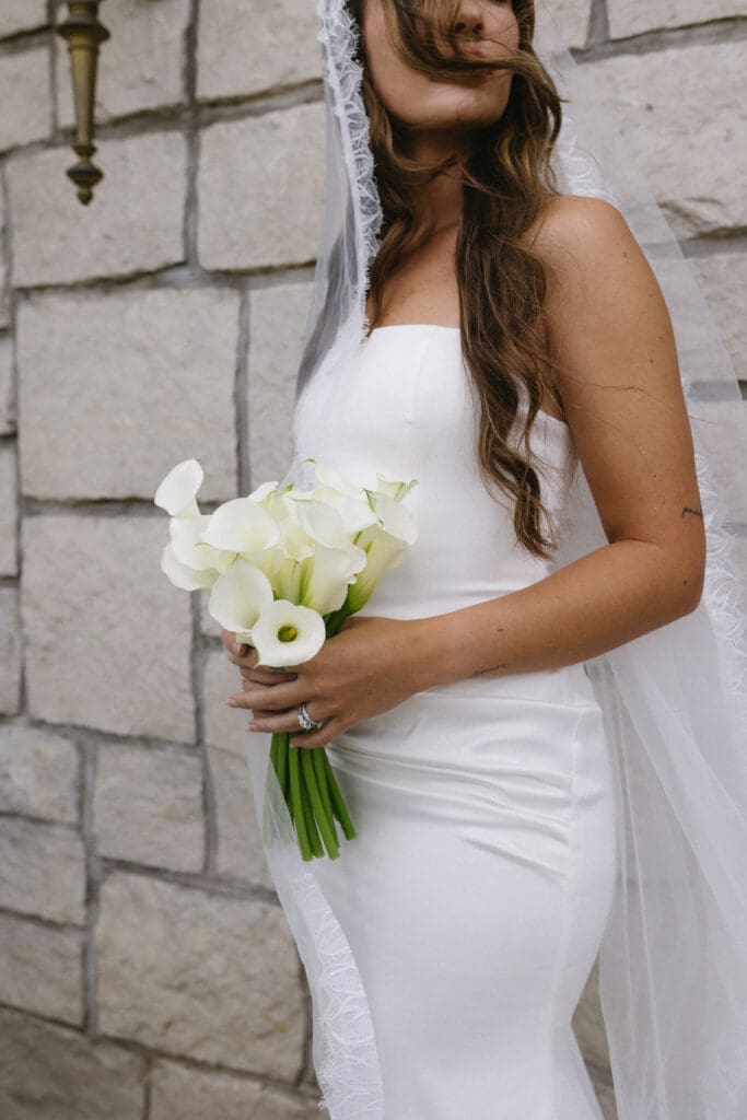 Bride holding a bouquet of calla lillies 