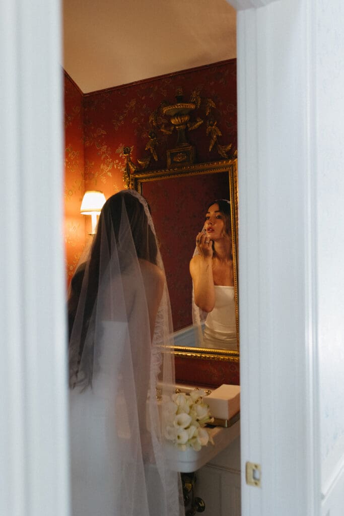Bride applying lipstick