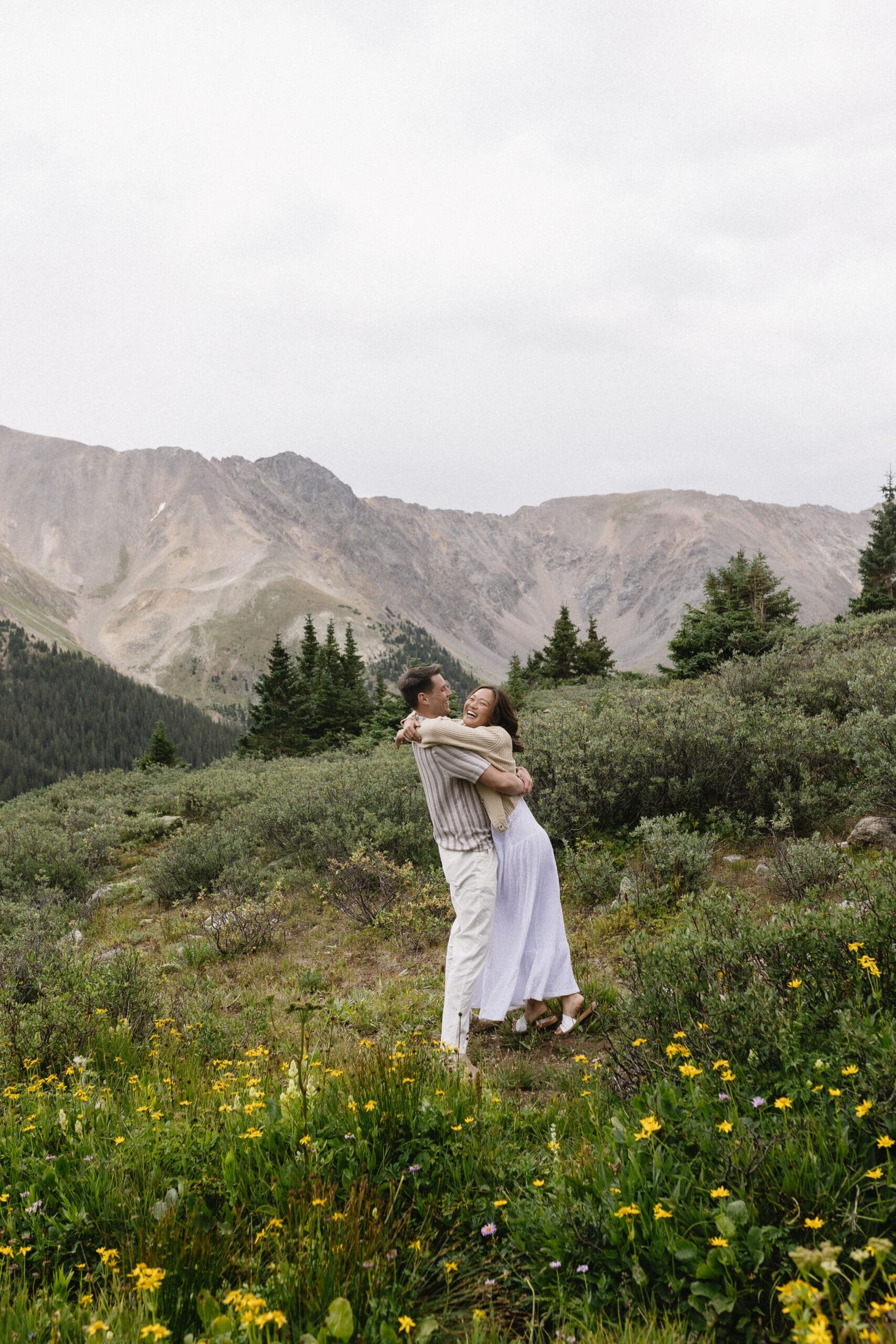 Couple holding onto each other in the Rocky Mountains
