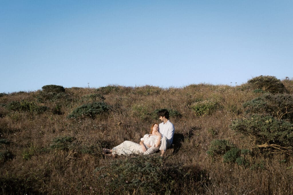 Couples pictured lying in the grass of Lookout Mountain in Colorado